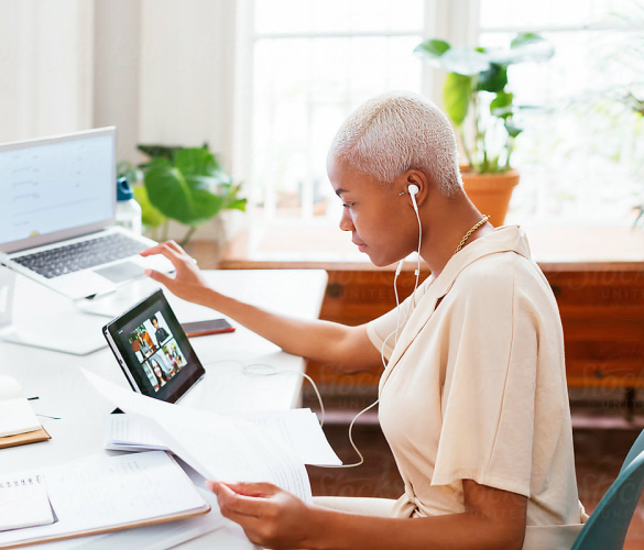 Woman working remotely on different devices at the same time