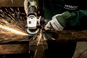 A manufacturing worker using a grinder which resembles crafstmanship